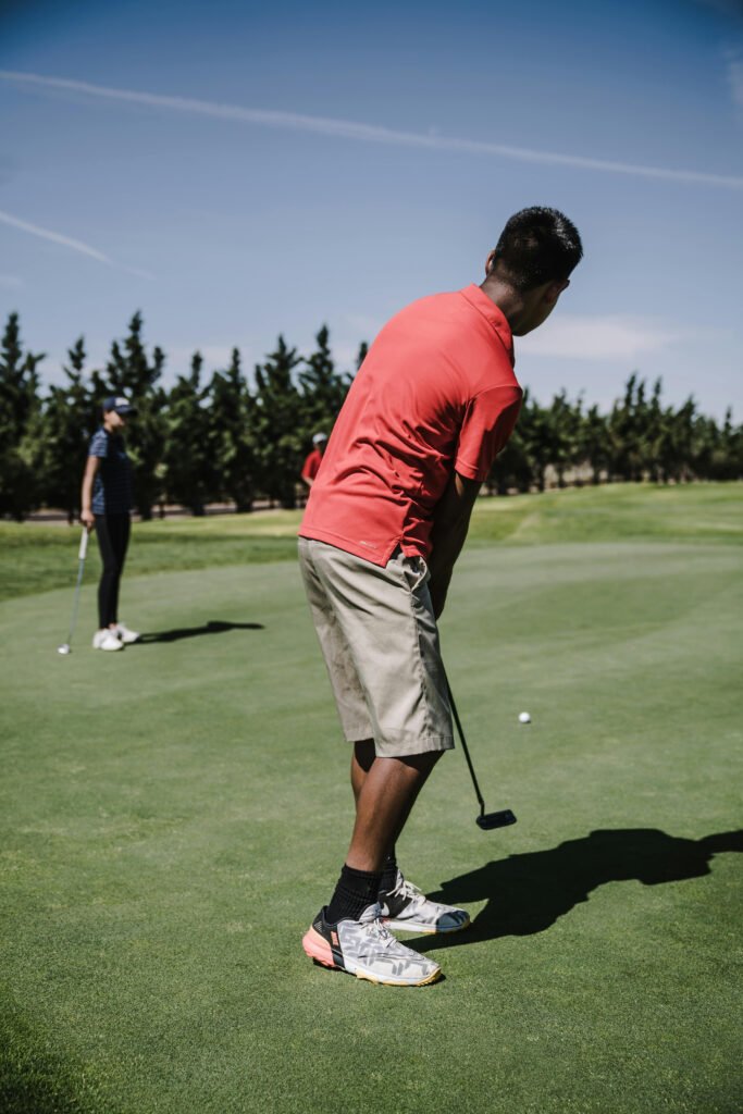 Golfer practicing the Gate Drill for putting on the green.